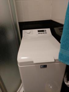 a white toilet in a bathroom with a blue towel at Apartman Dalmatino in Sutivan