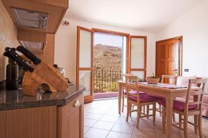 a kitchen with a table and a dining room at Agriturismo Benza in Imperia