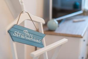 a blue and white sign on a white chair at Whg 08 - Fischers Lütte in Zingst