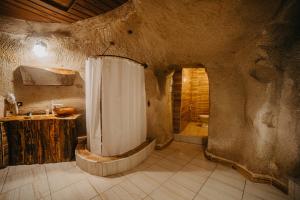 a large bathroom with a shower and a sink at Helios Cave Kapadokya in Ürgüp