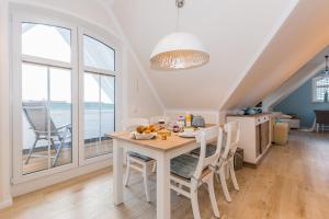 a kitchen and dining room with a table and chairs at Whg 08 - Fischers Lütte in Zingst