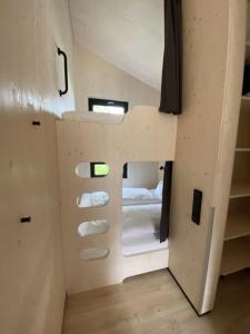 a tiny house with a bed in the middle at Naturlodges Edersee - Lodge #1 in Hemfurth-Edersee