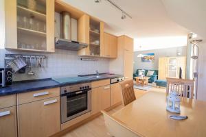 a kitchen with wooden cabinets and a wooden table with a counter top at Hoppenberg 5a in Zingst