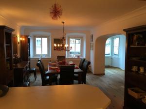 a dining room and living room with a table and chairs at Toni Sailer Haus apartment in Kitzbühel