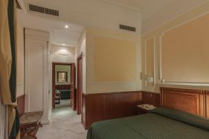 Postel nebo postele na pokoji v ubytování Hotel Borromeo