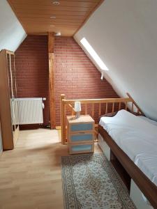 a bedroom with a bed and a small night stand with a nightstand at Ferienwohnung "Am Vaterlandsgrubenweg" - a57586 in Oelsnitz