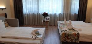 Postel nebo postele na pokoji v ubytování Pangea Hotel