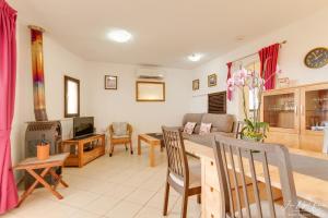 a living room with a couch and a table and chairs at Sobre de Granadella Haus 3 in Jávea