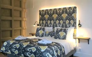 a bedroom with a bed with a black and white comforter at Hotel 1622 - Spa, Hotell & Konferens in Helsingborg