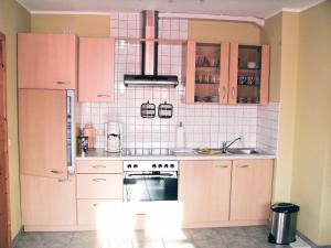 a kitchen with pink cabinets and a stove at Hütigendachs, FW 6 in Zingst