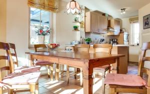 a kitchen and dining room with a wooden table and chairs at Deichweg 8 in Zingst