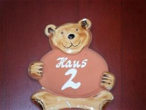 a teddy bear holding a sign with the number two at Ferienhaus Bliev-Hee Nr 2 in Klink