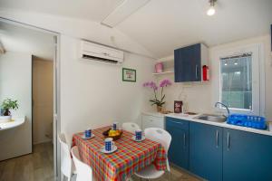 a kitchen with a table with a bowl of fruit on it at Camping La Pineta in Viareggio