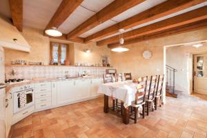 a kitchen with a table and chairs in a room at Villa Gelci in Trget