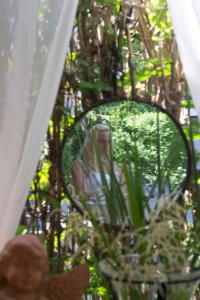a reflection of a woman in a mirror at Pension Stissen Haus am See in Faak am See