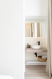 a bathroom with a sink and a mirror at Suites Alfonso X in Jerez de la Frontera