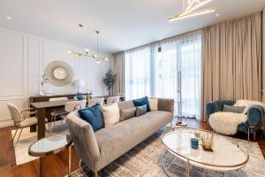 a living room with a couch and a table at 2BR With Direct Pool Access City Walk B9 in Dubai
