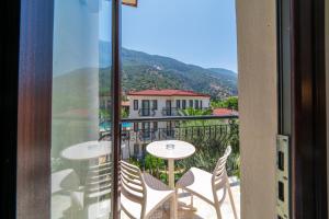 a view of a balcony with tables and chairs at Sundia By Liberty Oludeniz in Oludeniz