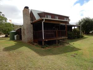 a house sitting on top of a grass field at Ashanti House - Living The Breede in Malgas