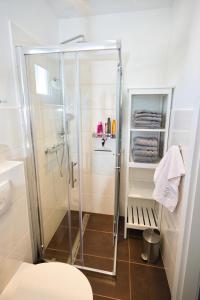 a bathroom with a shower with a toilet and towels at Vila Punta in Stomorska +27 photos