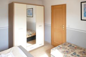 a bedroom with a mirror next to a bed at Kolja in Zingst