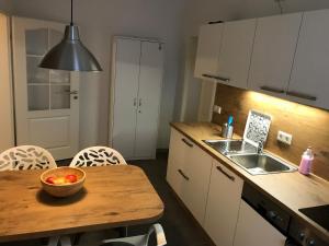 a kitchen with a bowl of fruit on a wooden table at Zum Notar in Brand-Erbisdorf