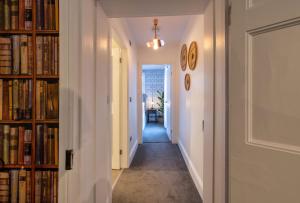 a hallway with book shelves filled with books at Contemporary Apartment on the Historic Rows in Chester