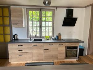 a kitchen with a sink and a stove top oven at La Bassurelle in Saint-Valéry-sur-Somme