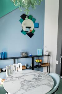 a dining room table with chairs and a clock on the wall at Dimoramare Manarola, Terre Marine in Manarola