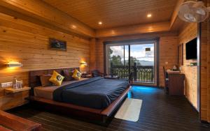 a bedroom with a bed in a wooden cabin at The Hosteller Kasar Devi in Almora