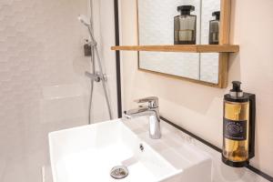 a bathroom with a white sink and a mirror at Hôtel Life Marseille VP - Vieux Port in Marseille +16 photos