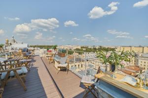 a balcony with tables and chairs on a roof at Grand Catherine Palace Hotel in Saint Petersburg