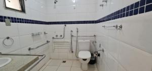 a bathroom with a toilet, sink, and shower stall at Hotel El Pilar in Brasília