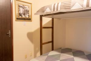a bunk bed with a ladder in a room at Apart vitória in Feira de Santana