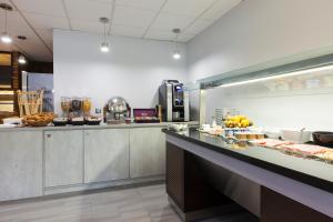 a buffet line in a restaurant with food at Comfort Hotel Evreux in Évreux +28 photos