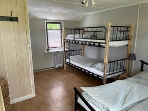 Cette chambre comprend 2 lits superposés et une fenêtre. dans l'établissement De Bargsche Hoeve, à Azewijn