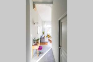 a hallway with a door leading to a living room at La Chassagne, en plein cœur de ville in Dijon