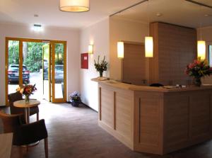a hotel lobby with a reception counter and a table at Hotel zur Ostsee in Graal-Müritz
