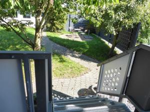 a bench sitting on a porch with a walkway at Zum Roemernest in Würzberg