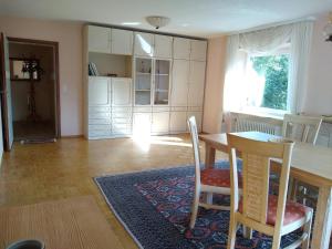 a kitchen with a table and chairs and a dining room at Burgblick-Fewo Töpfer in Annweiler am Trifels