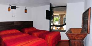 a room with three beds and a window at Casinha da Horta in Soajo