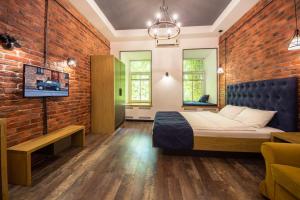 a bedroom with a bed and a brick wall at Central Dayflat Apartments in Kyiv