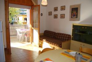 a living room with a couch and a table at Condominio San Michele in Bibione