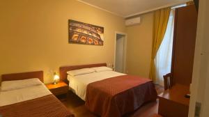 a hotel room with two beds and a window at Sole E Luna in Rome