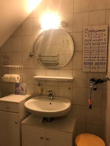 a bathroom with a sink and a mirror at Schöne Auszeit RE14 in Sögel