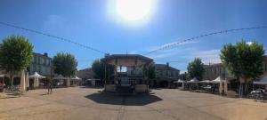 a large plaza with a fountain in the middle of a city at Logis Hôtel Restaurant Métropole in Mirande