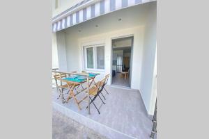 a view of a patio with a table and chairs at DiFan Sea Homes A3 in Kalamata