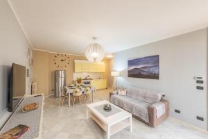 a living room with a couch and a table at DiVino Holiday Apartments in Alba