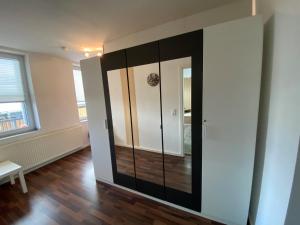 a large black and white wardrobe in a room at Alte Molkerei FeWo 1 in Zilly