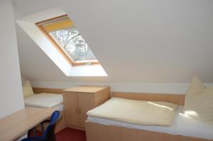 a dorm room with a bed and a window at Am Deich 15 in Zingst